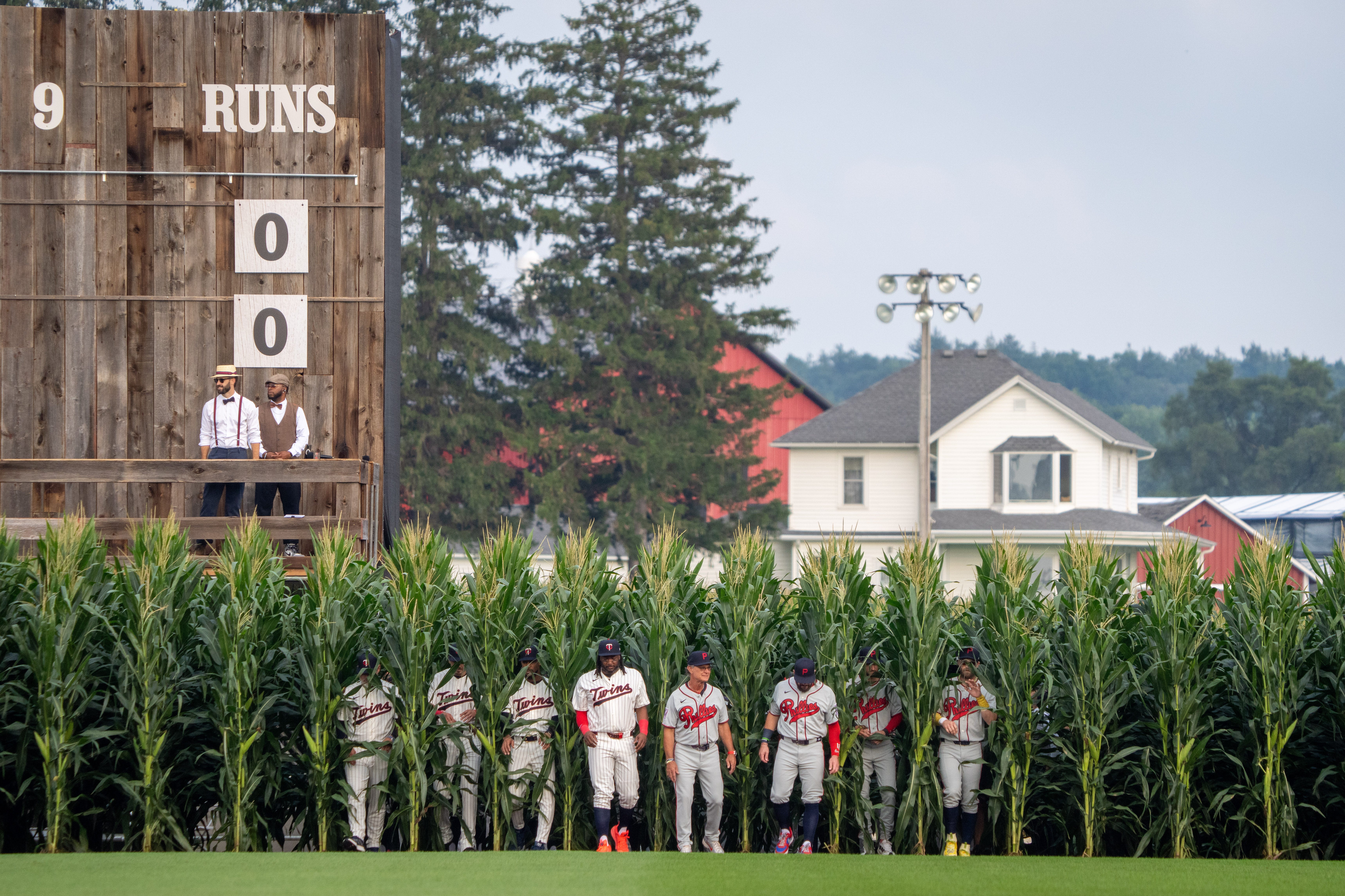 Players walk onto the field before a baseball game between the Minnesota Twins and the Philadelphia Phillies at the Field of Dreams movie site, Thursday, Aug. 13, 2026, in Dyersville, Iowa.