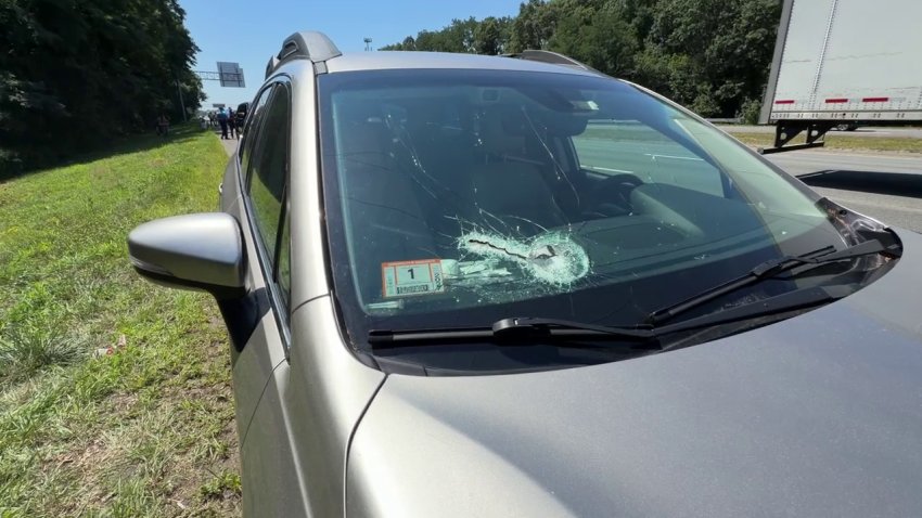 A car with a hole in its windshield on the side of I-95 in Peabody, Massachusetts, on Friday, Aug. 7, 2026.