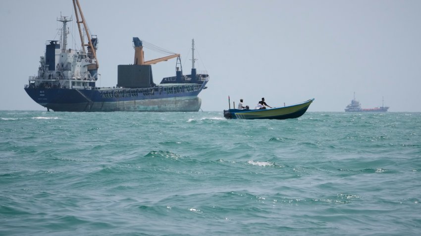 A motorboat passes a general cargo ship anchored in the Strait of Hormuz off Bandar Abbas, Iran, Sunday, Sept. 6, 2026.