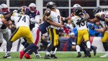 Christian Ellis jars the ball free from Aaron Rodgers.