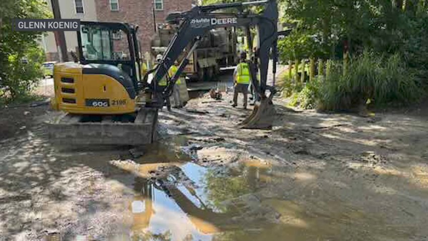 An excavator by debris from a water main break in Maynard, Massachusetts.
