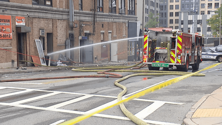 A Boston fire truck spraying water in a structurally unsafe building in Roxbury on Tuesday, Sept. 29, 2026, a day after a fire erupted inside.