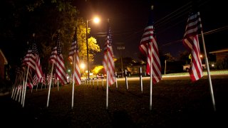 File - Flags and crosses to honor those killed and wounded by U.S. Army Major Nidal Malik Hasan in a shooting rampage at Fort Hood on Nov. 6, 2009 in Killeen, Texas.