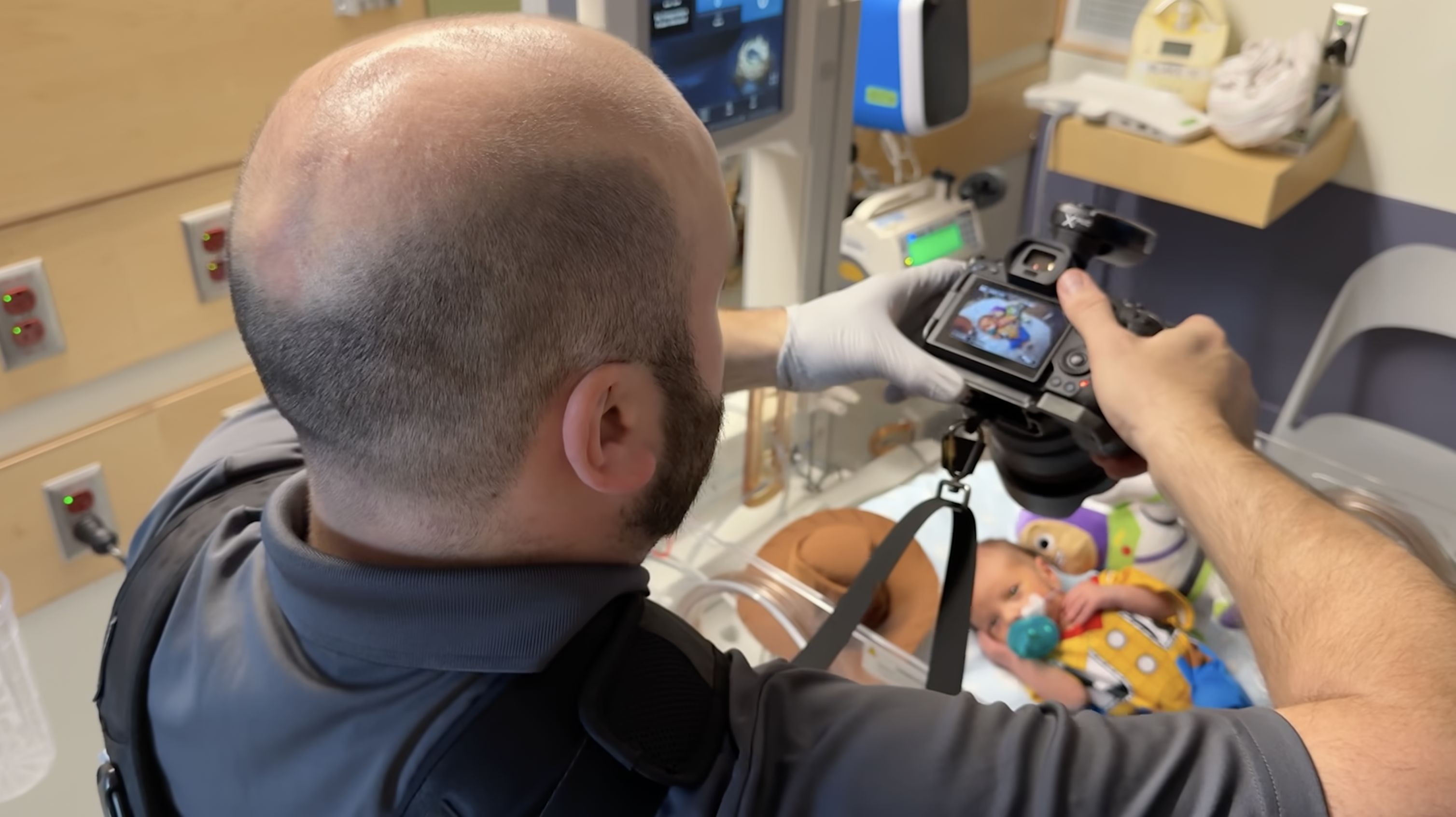 Massachusetts General Hospital staff photographer Jeffrey Andree taking a picture of a baby in the NICU.