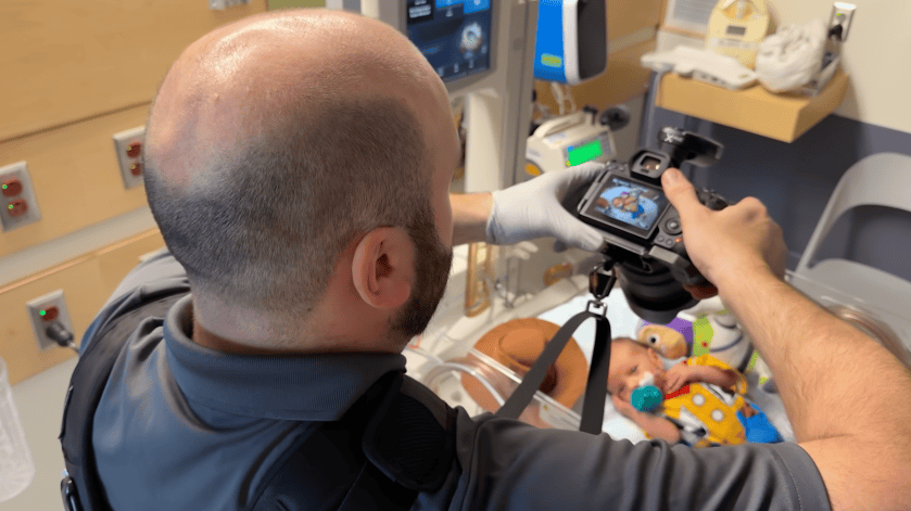 Massachusetts General Hospital staff photographer Jeffrey Andree taking a picture of a baby in the NICU.
