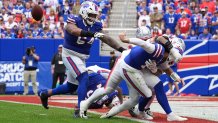 Josh Allen throws a backward pass to avoid tacking a sack near the goal line against the Patriots.